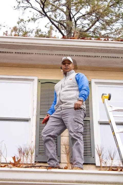Client supplied photo of an inspector examining a roof before listing